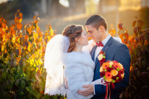 Autumn wedding bride and groom on the street sunny