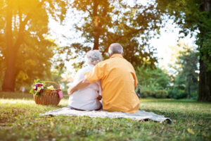 Happy and lovely senior couple enjoying a picnic in the park