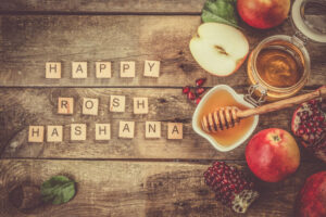 Rosh hashana jewish holiday concept - apples, honey, pomegranate