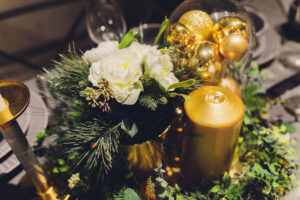 Gold Christmas background of de-focused lights with decorated tree